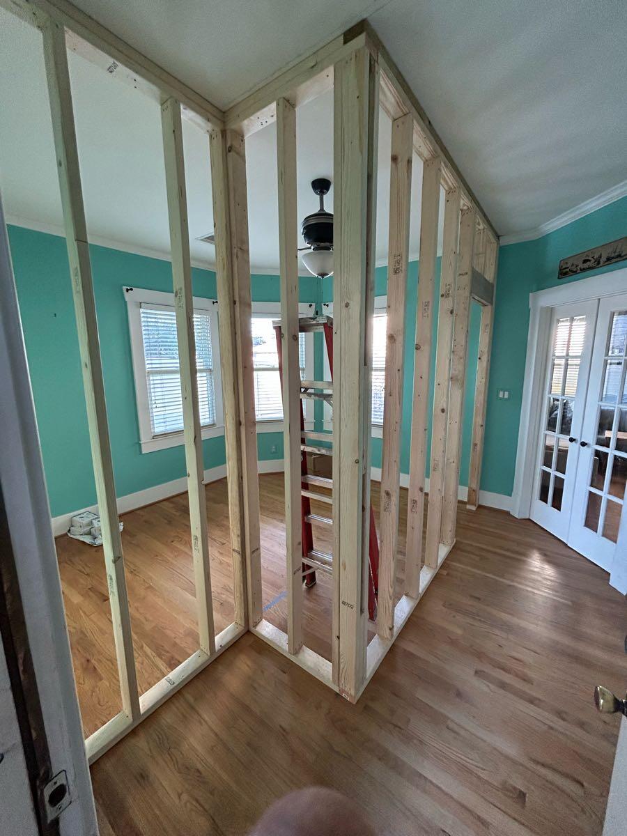 New stud walls and doorway framing during a Heights office-to-nursery conversion